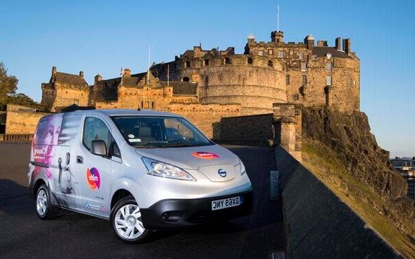 EV silver van with Mitie branding in the foreground, with Edinburgh Castle in the background
